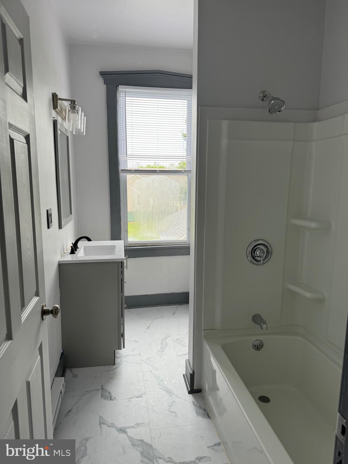 108 West State Street, Unit B Quarryville, PA 17566 - Photo 4 of 4 a bathroom with a tub a sink and a window