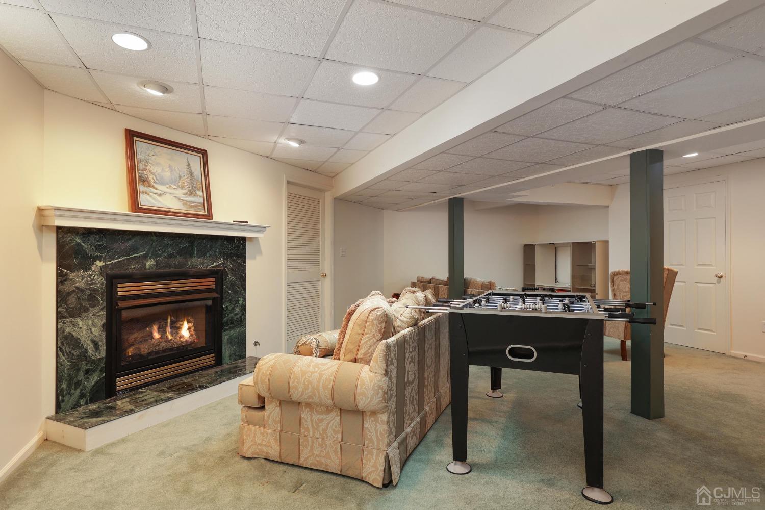 7 Yardley Manor Drive Old Bridge, NJ 07747 - Photo 21 of 23 a living room with furniture a fireplace and kitchen view