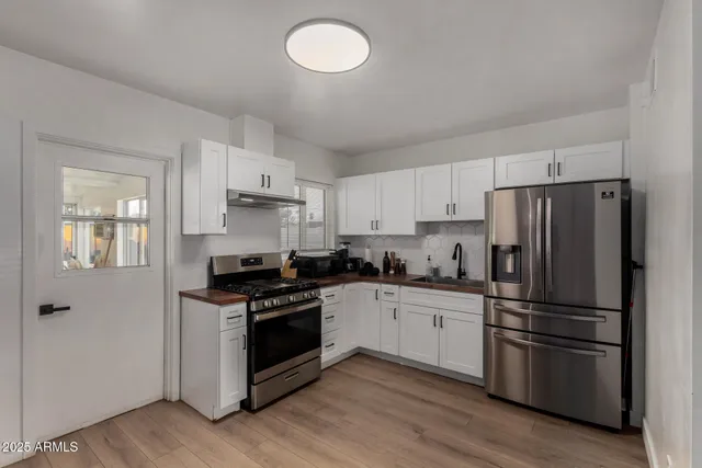a kitchen with stainless steel appliances and wooden cabinets