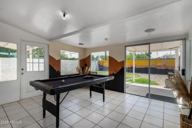 a view of a room with furniture and large windows
