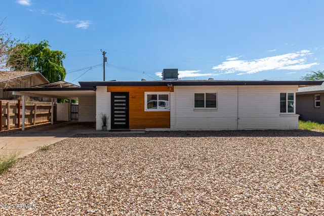 a front view of a house with a garden