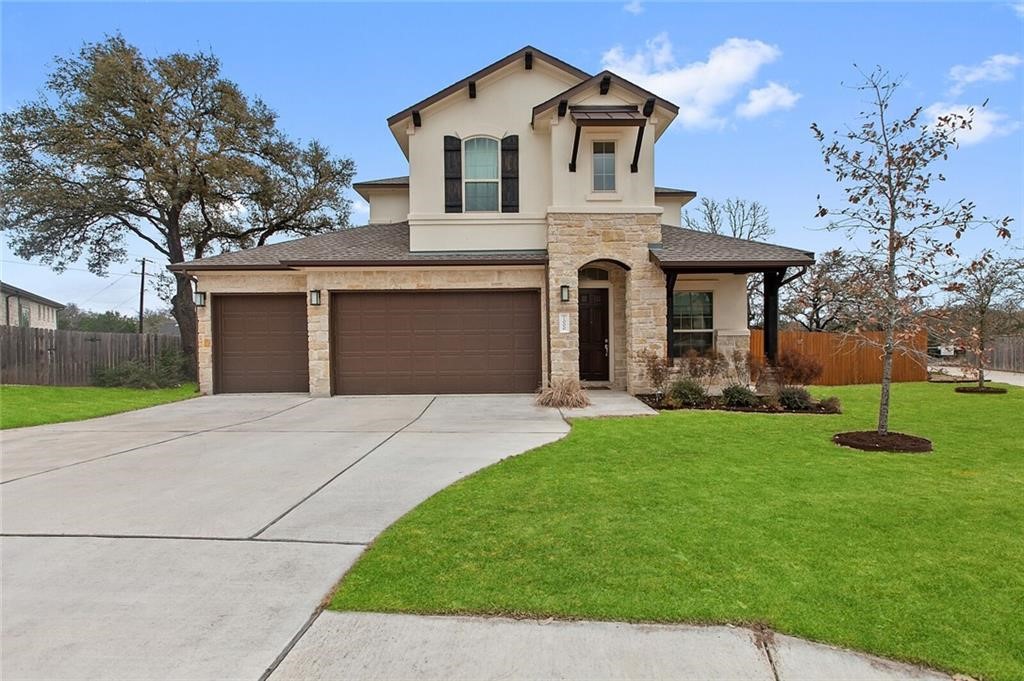 a front view of a house with a yard and garage