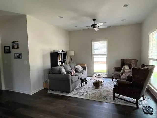 a living room with furniture window and wooden floor