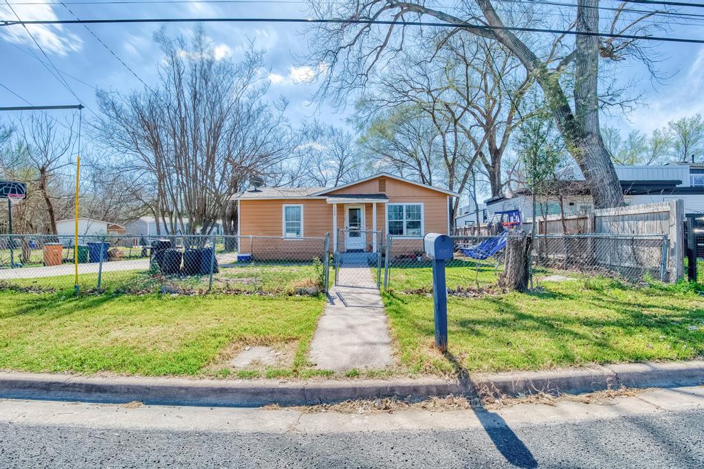 a front view of a house with a yard table and chairs