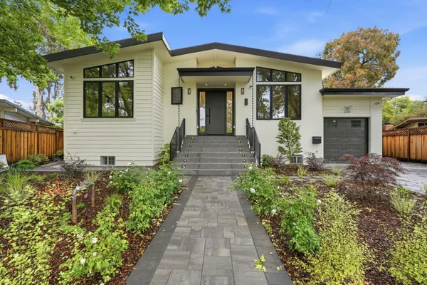 a front view of a house with garden