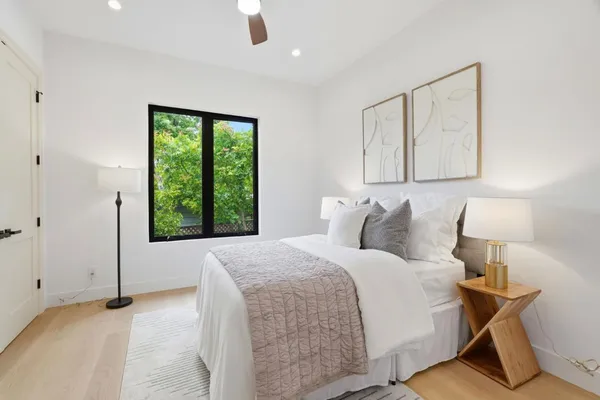 a bedroom with a bed and a window