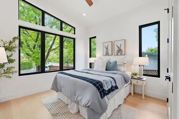 a bedroom with a large bed and a large window