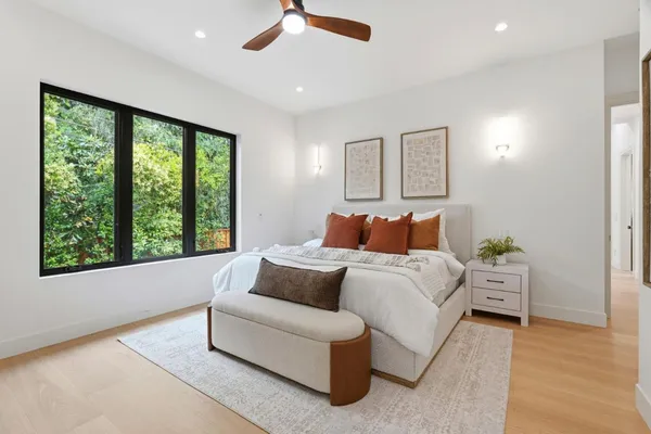 a bed room with a bed and a large window