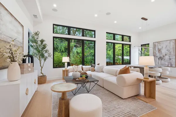 a living room with furniture and large windows