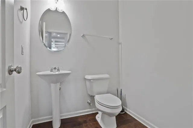 a bathroom with a toilet a sink and a mirror