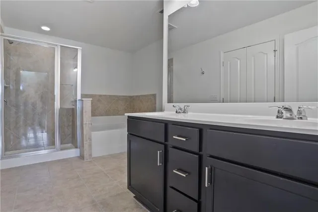 a bathroom with a sink double vanity and a shower