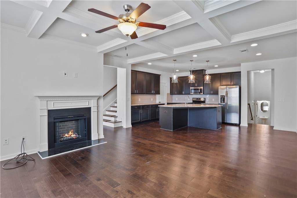 7725 Rutgers Circle Fairburn, GA 30213 - Photo 5 of 20 a view of an empty room with kitchen and fireplace