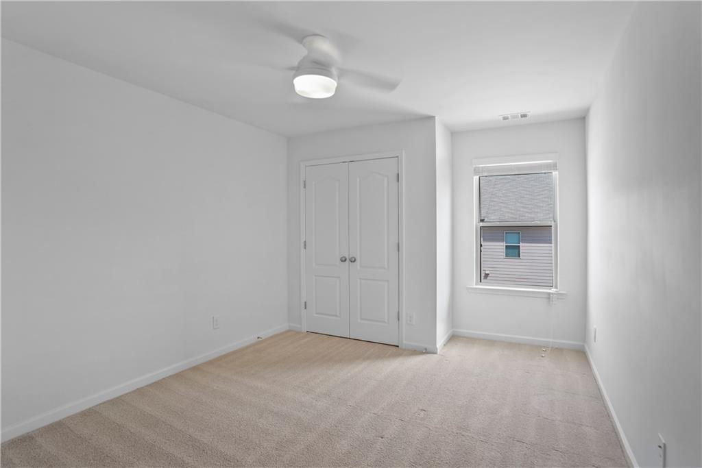 7725 Rutgers Circle Fairburn, GA 30213 - Photo 9 of 20 a view of an empty room and a window