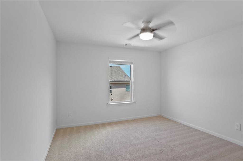 7725 Rutgers Circle Fairburn, GA 30213 - Photo 10 of 20 an empty room with a window and a fan