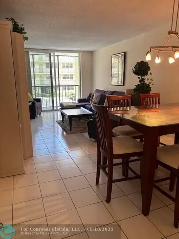 a living room with furniture a flat screen tv and a window