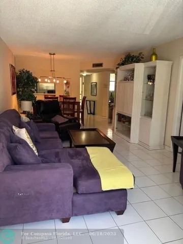 a living room with furniture and a kitchen