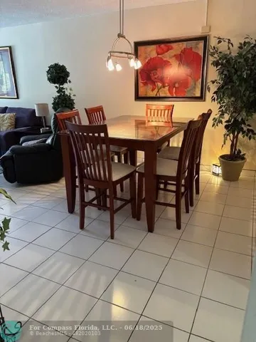a dining room with furniture and a flat screen tv