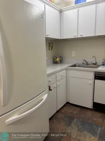 a kitchen with white cabinets