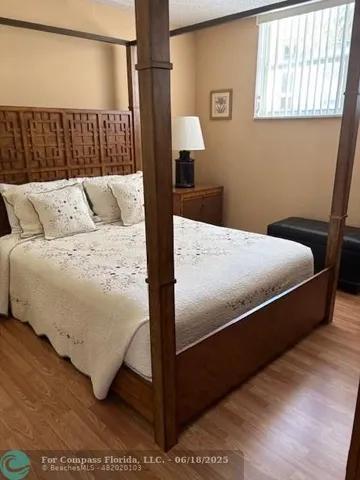 a bed sitting in a bedroom next to a window