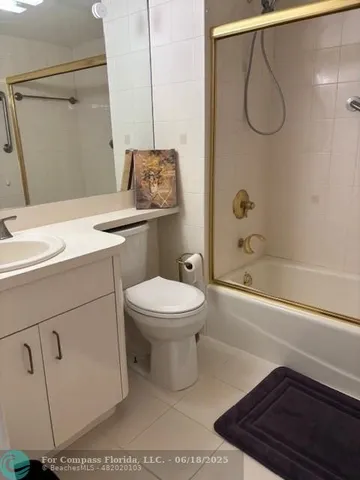 a bathroom with a toilet sink and shower
