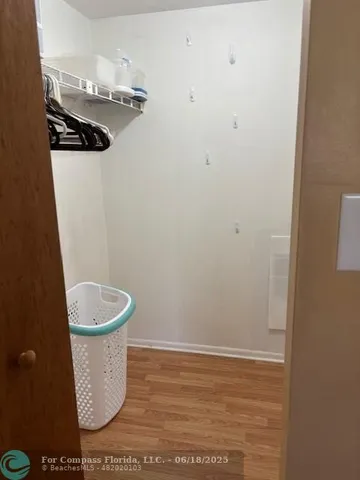 a view of a room with wooden floor