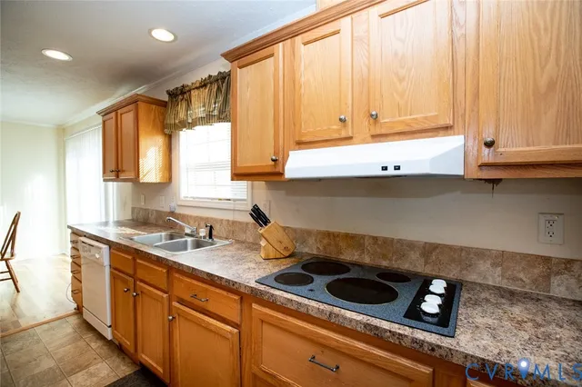 a kitchen with stainless steel appliances granite countertop a sink a stove and a microwave