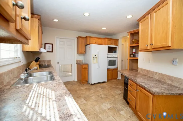 a kitchen with stainless steel appliances granite countertop a refrigerator and a sink