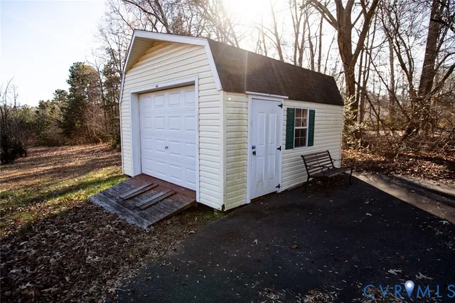 a view of a small house with yard and tree s