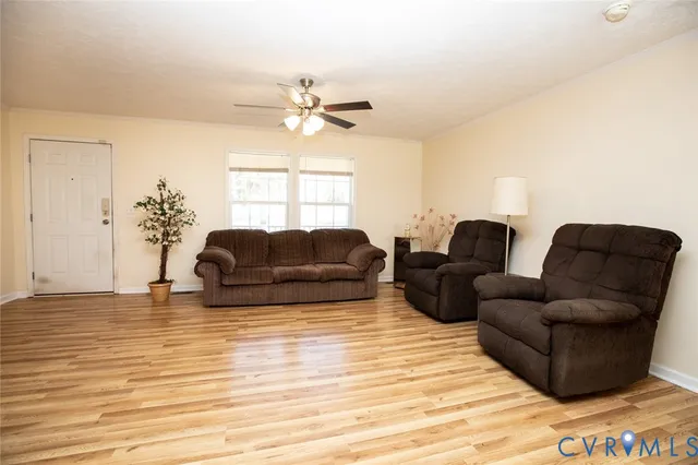 a living room with furniture and a wooden floor