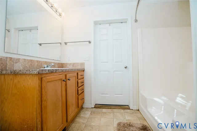 a bathroom with a shower and a sink