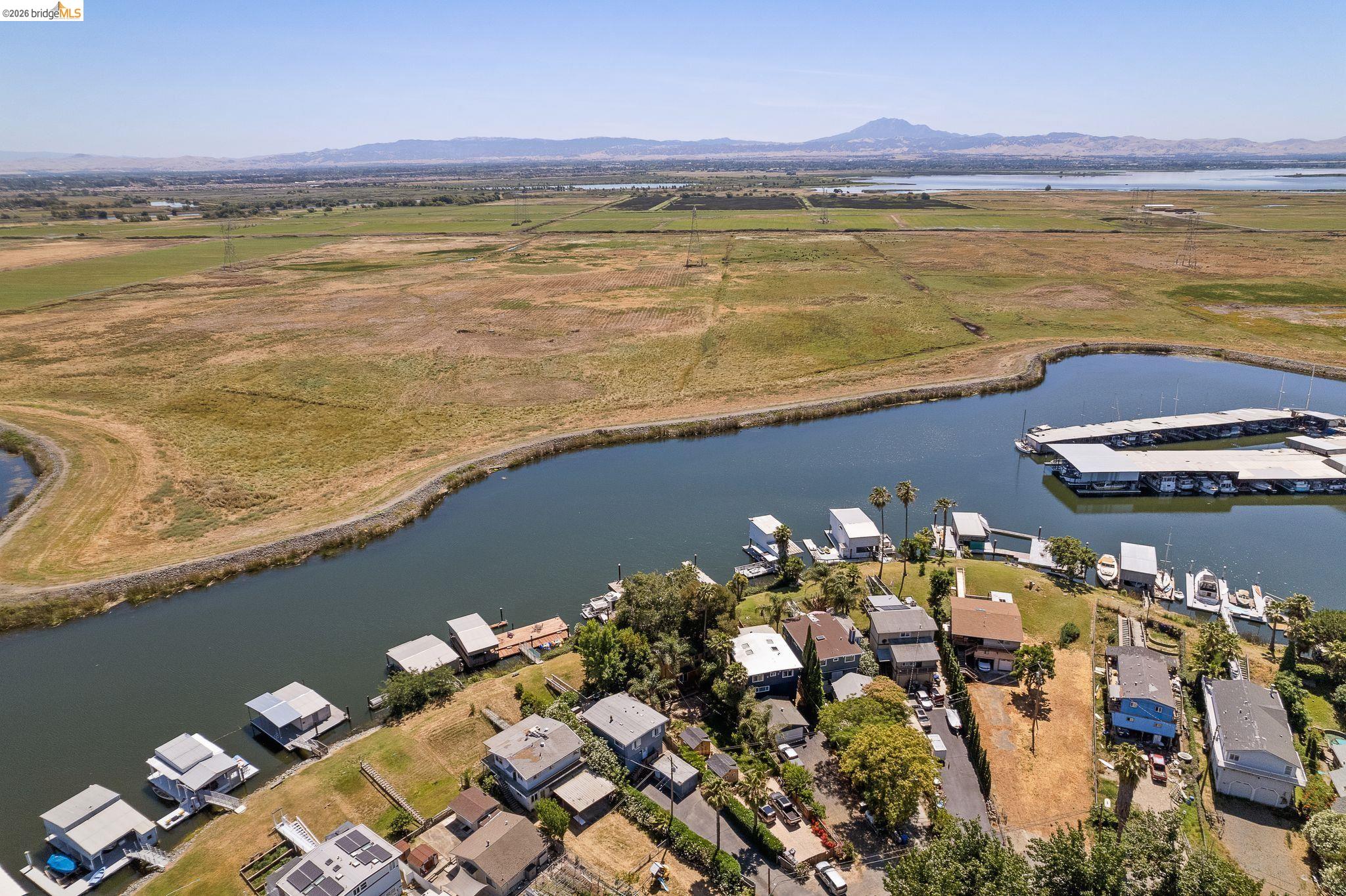 1704 Taylor Road Bethel Island, CA 94511 - Photo 69 of 73 Aerial perspective showcasing waterfront properties, a marina with covered slips, and a natural waterway