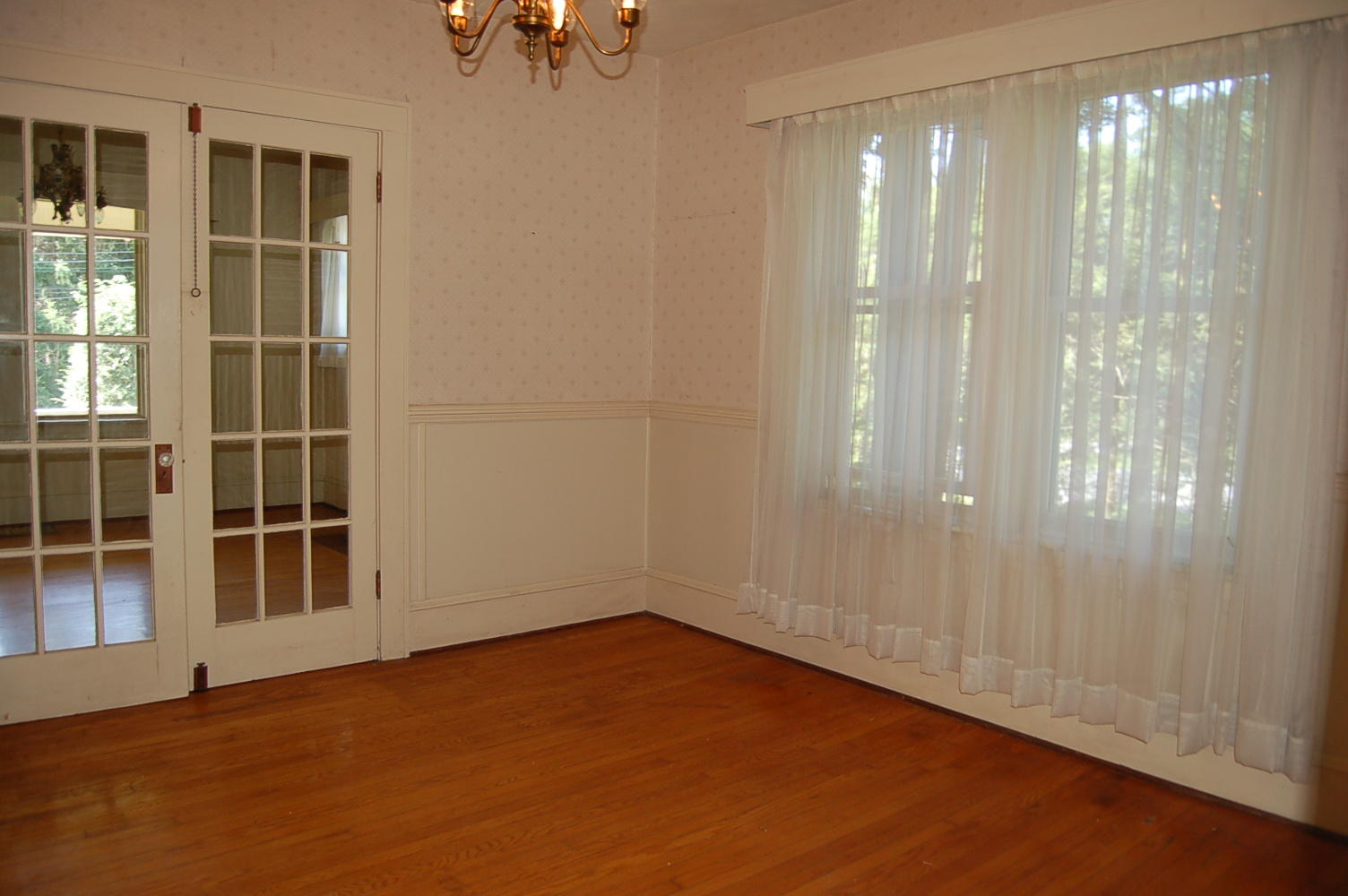 48 Fields Avenue Blue Ridge, VA 24064 - Photo 9 of 46 a view of an empty room with wooden floor and windows