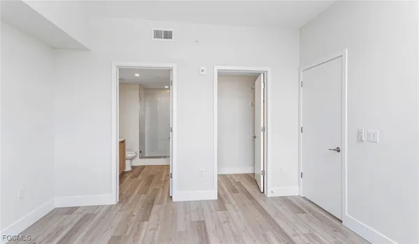 a view of hallway with wooden floor