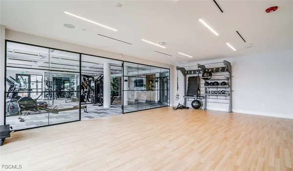 a view of a big room with an empty room and floor to ceiling window