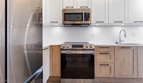 a kitchen with stainless steel appliances granite countertop a stove and a refrigerator
