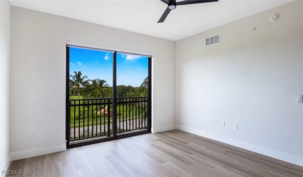 a view of a room with wooden floor and windows