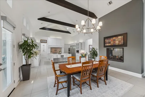 a view of a dining room with furniture and chandelier