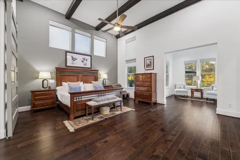 a bedroom with furniture and a wooden floor