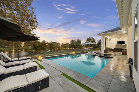 a view of swimming pool with outdoor seating and city view