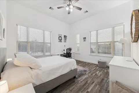 a bedroom with a large bed and a window