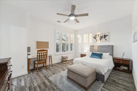 a bedroom with a bed and a large window