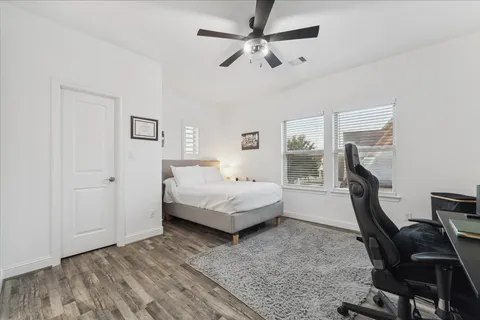 a bedroom with a bed window and a desk