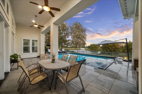 a balcony with furniture and a floor to ceiling window