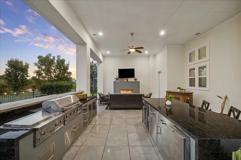 a large kitchen with stainless steel appliances a stove and a sink