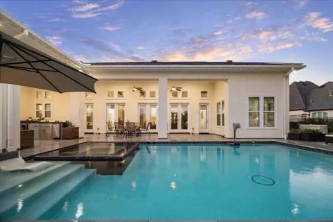 a view of a patio with swimming pool table and chairs