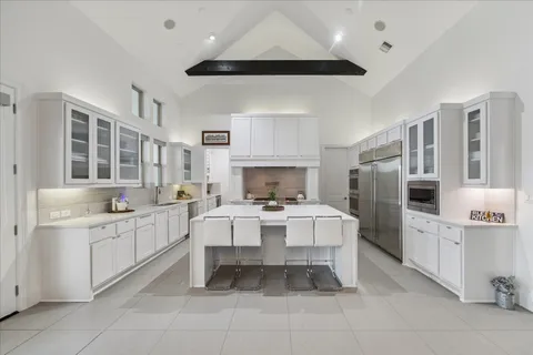 a white kitchen with a sink stove and microwave