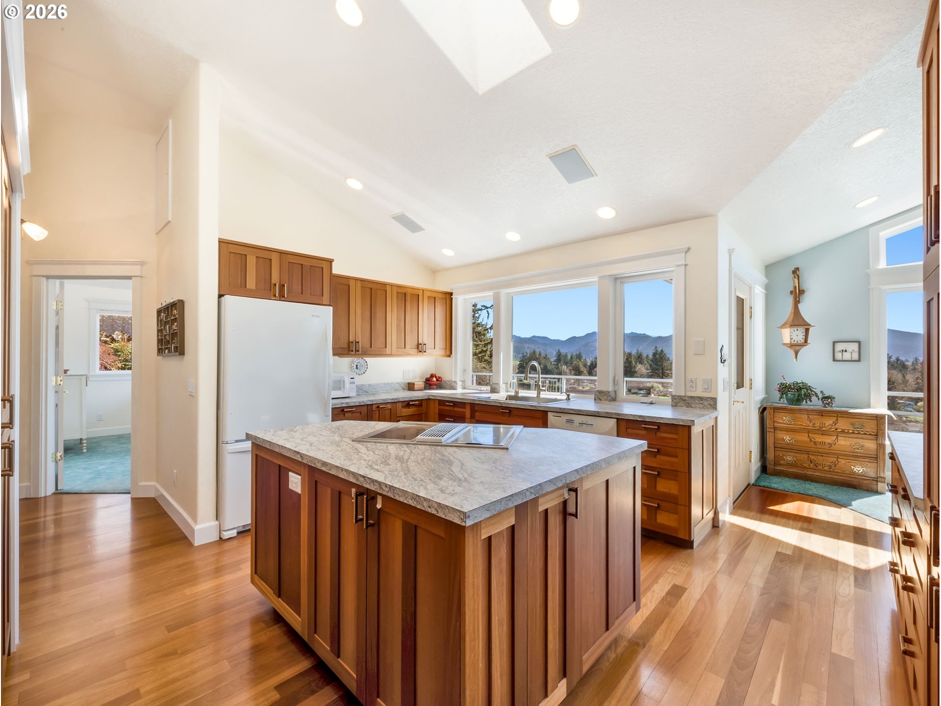 14115 Riverview Meadows Lane Nehalem, OR 97131 - Photo 17 of 39 a kitchen with a refrigerator a sink and wooden floor