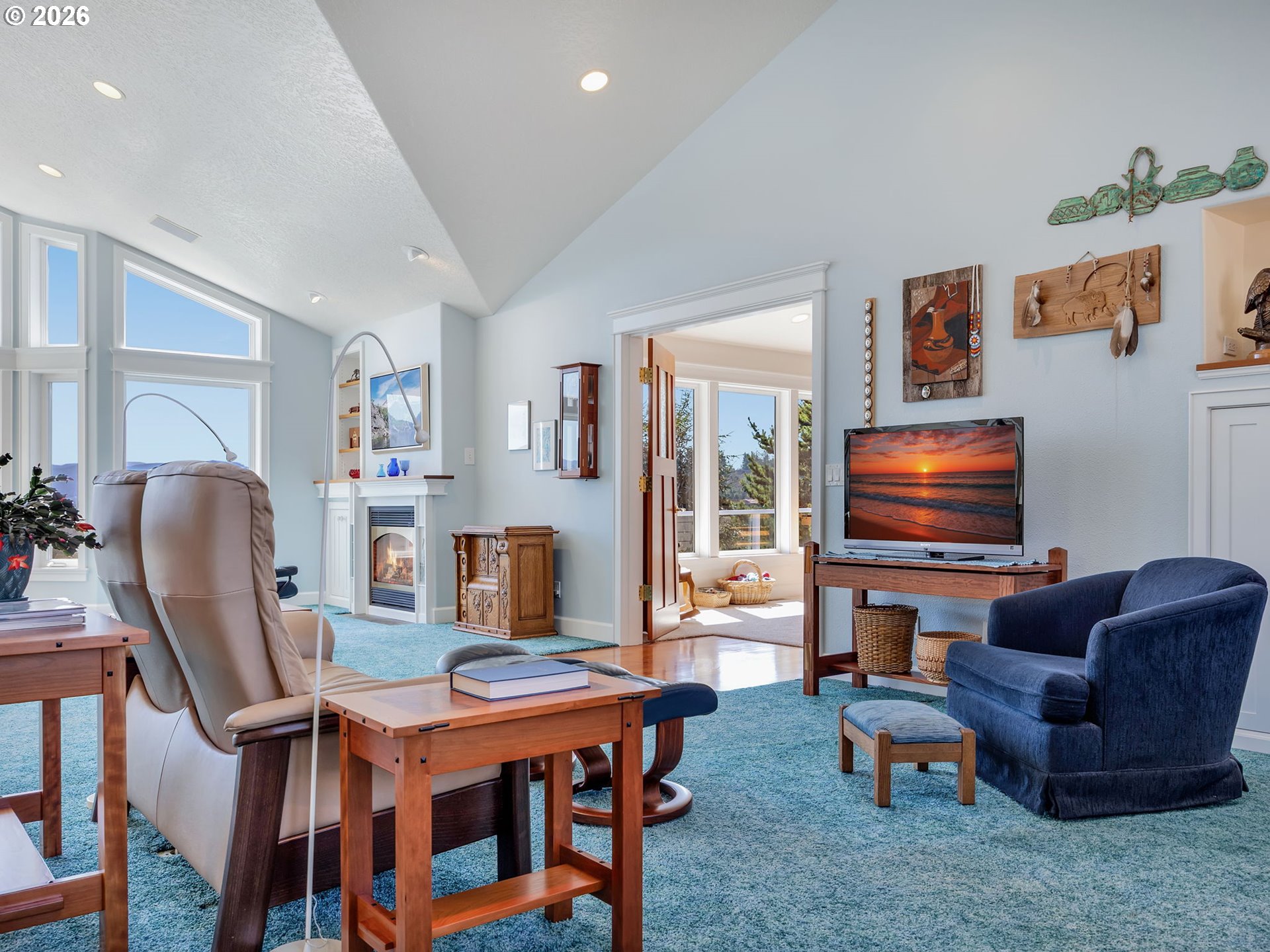 14115 Riverview Meadows Lane Nehalem, OR 97131 - Photo 19 of 39 a living room with furniture a flat screen tv and a floor to ceiling window