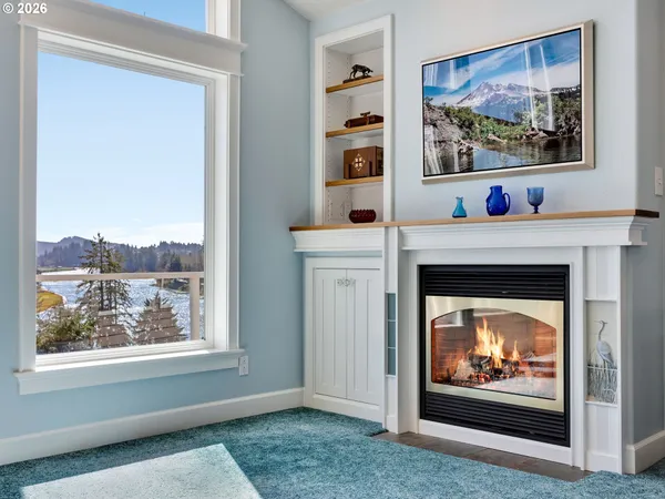 a living room with a fireplace and a painting on the wall