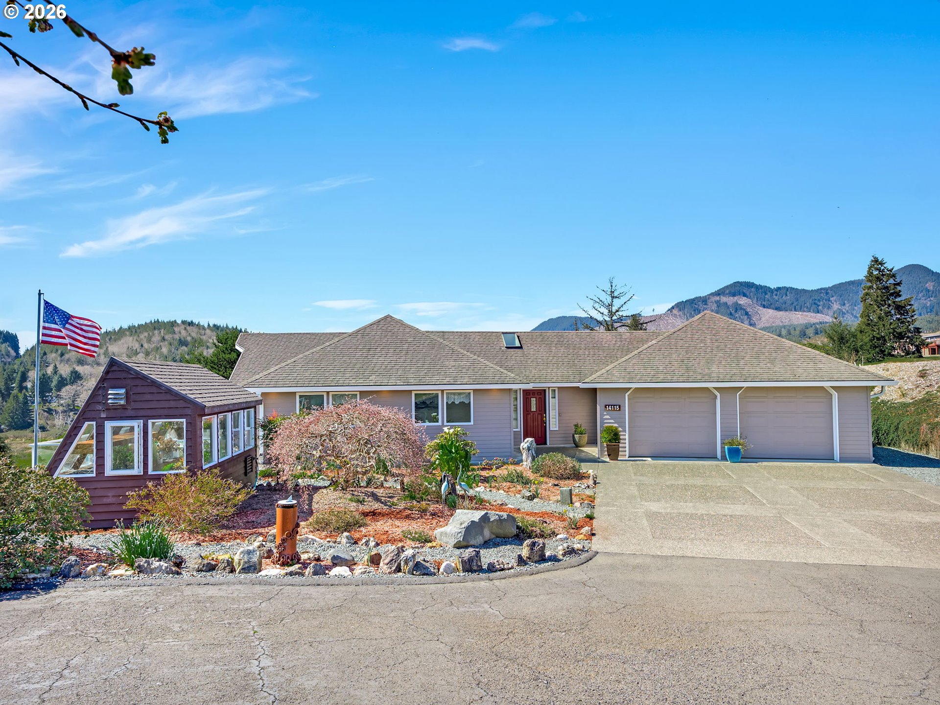 14115 Riverview Meadows Lane Nehalem, OR 97131 - Photo 2 of 39 a front view of a house with garden